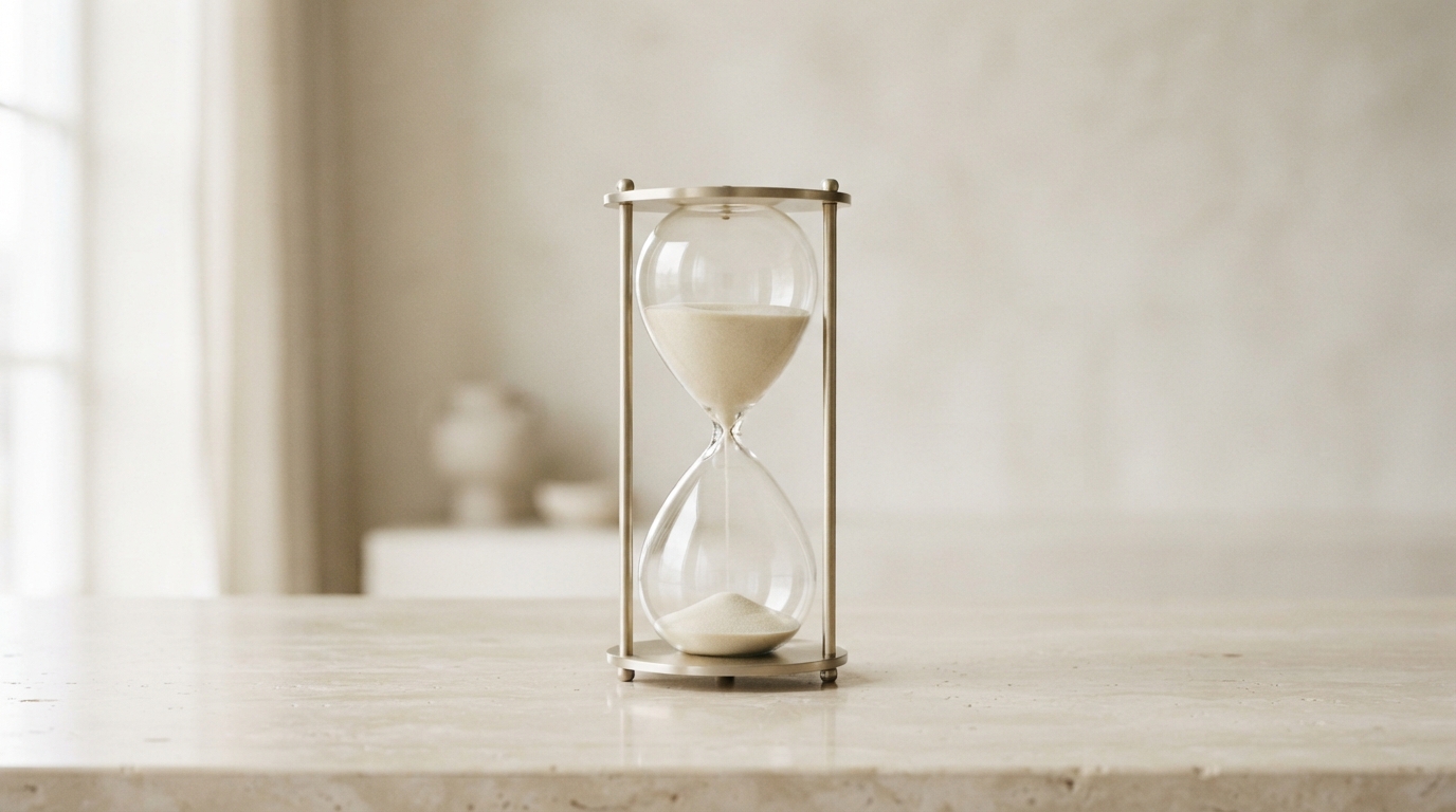 Hourglass on a stone counter, representing monthly credits that expire and renders deleted after 30 days